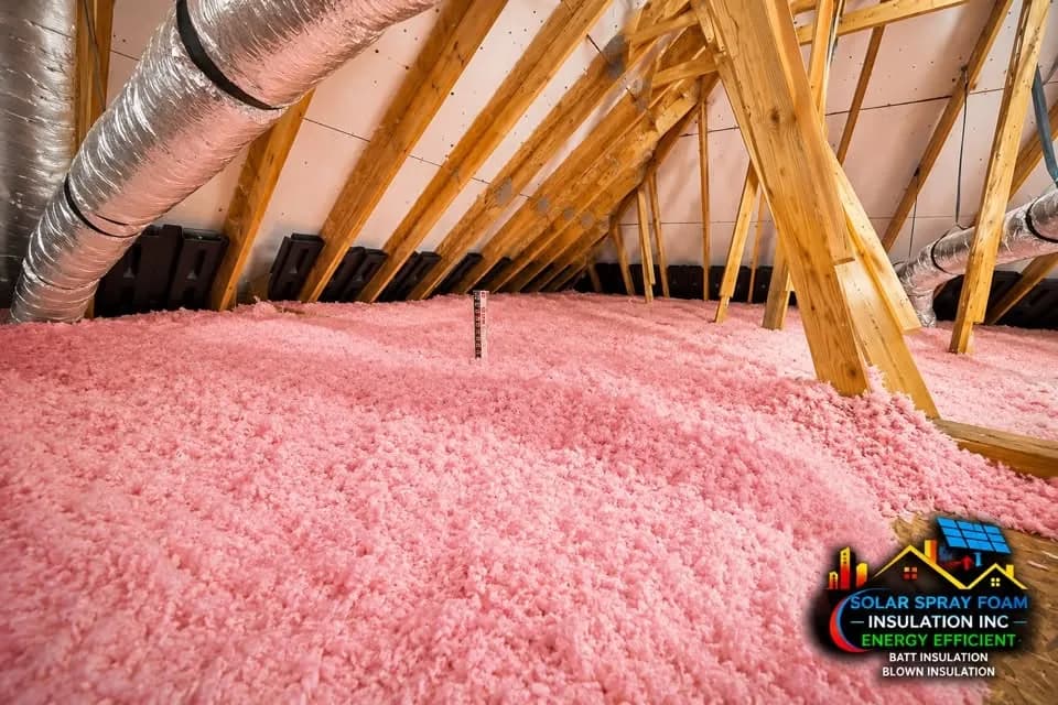 Blown-in fiberglass attic insulation installed to depth in an Elgin, IL home, with a depth gauge marking the finished level