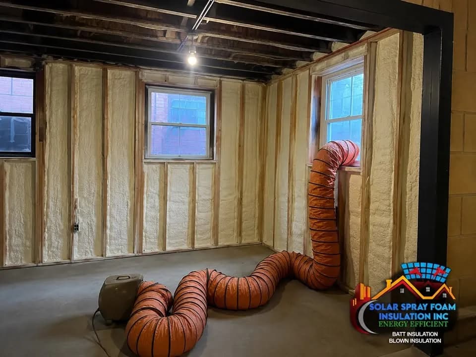 Basement wall spray foam insulation project in Elgin, IL, with framed walls fully foamed between the studs