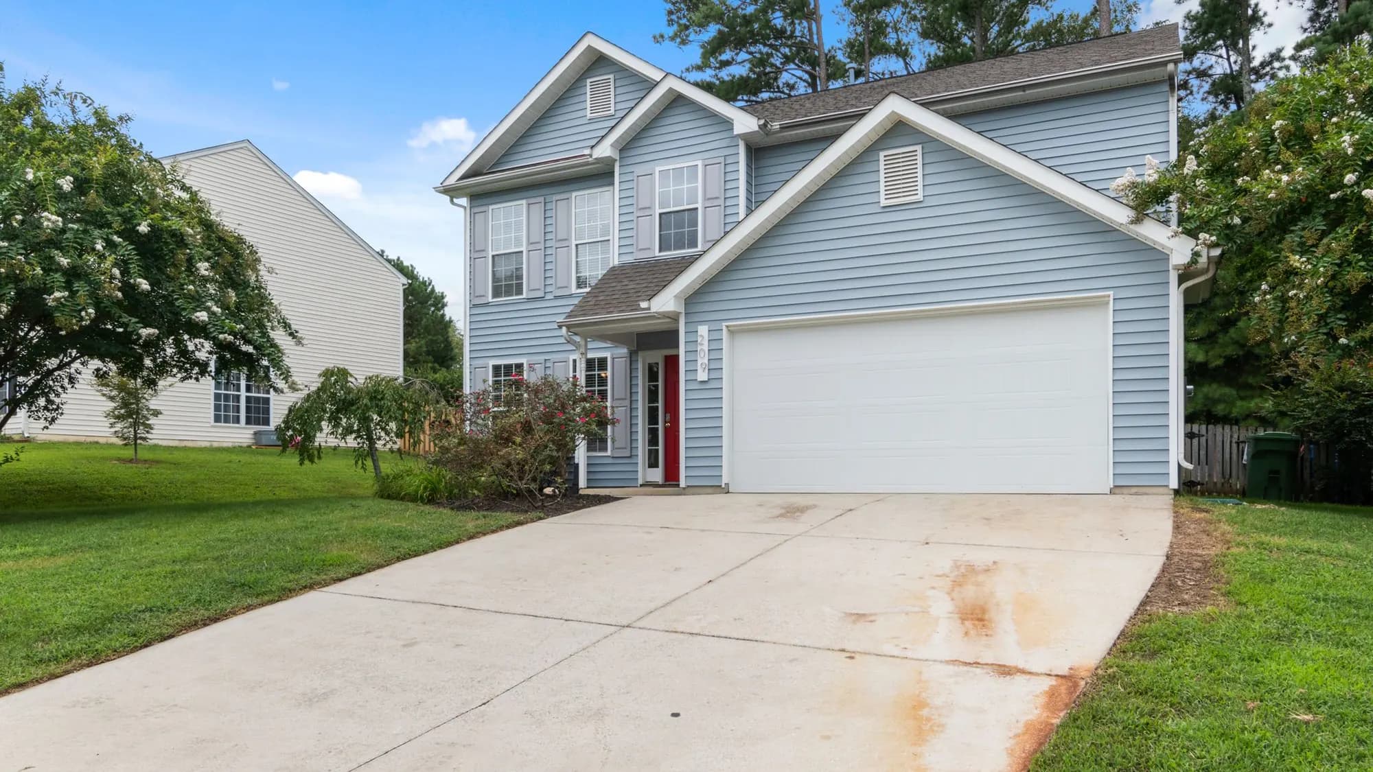 Residential street of family homes with mature trees and front lawns — the kind of home we insulate in Burlington, IL