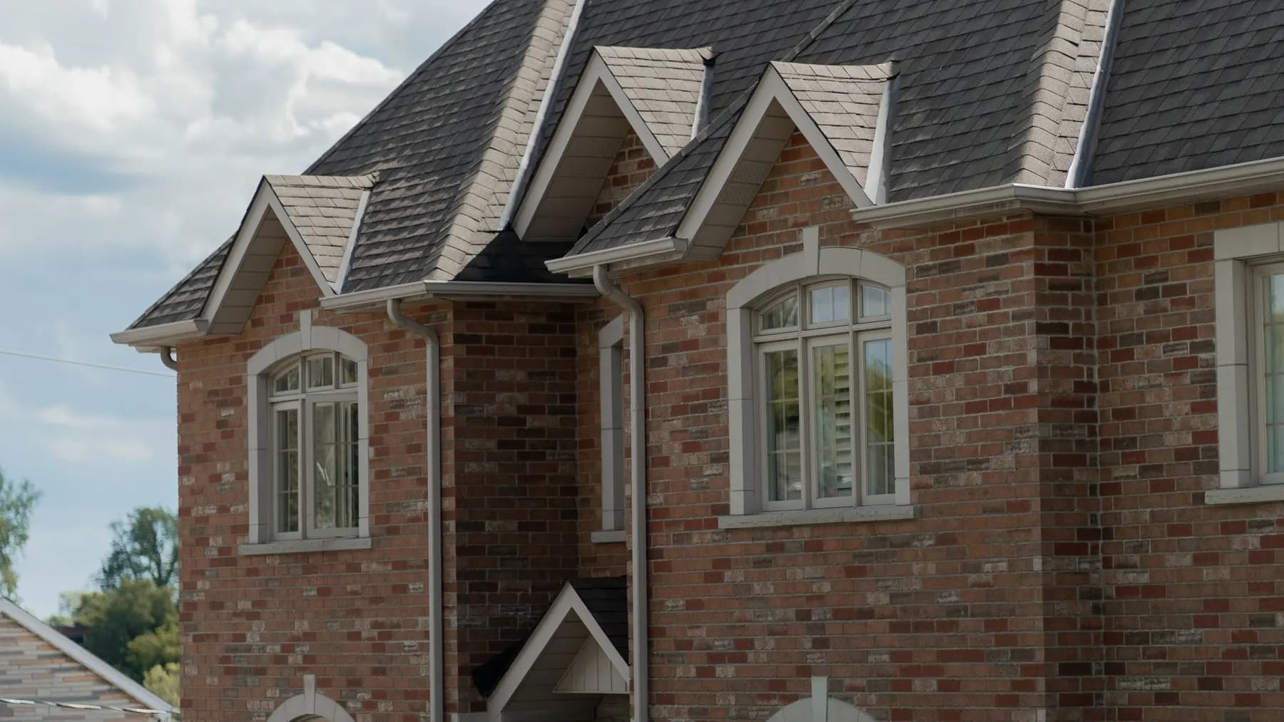 Residential rooftops and gables seen from the street